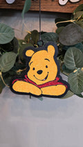Handmade honey bear-inspired car freshie featuring a smiling bear wearing a red shirt, designed as a scented rearview mirror accessory.