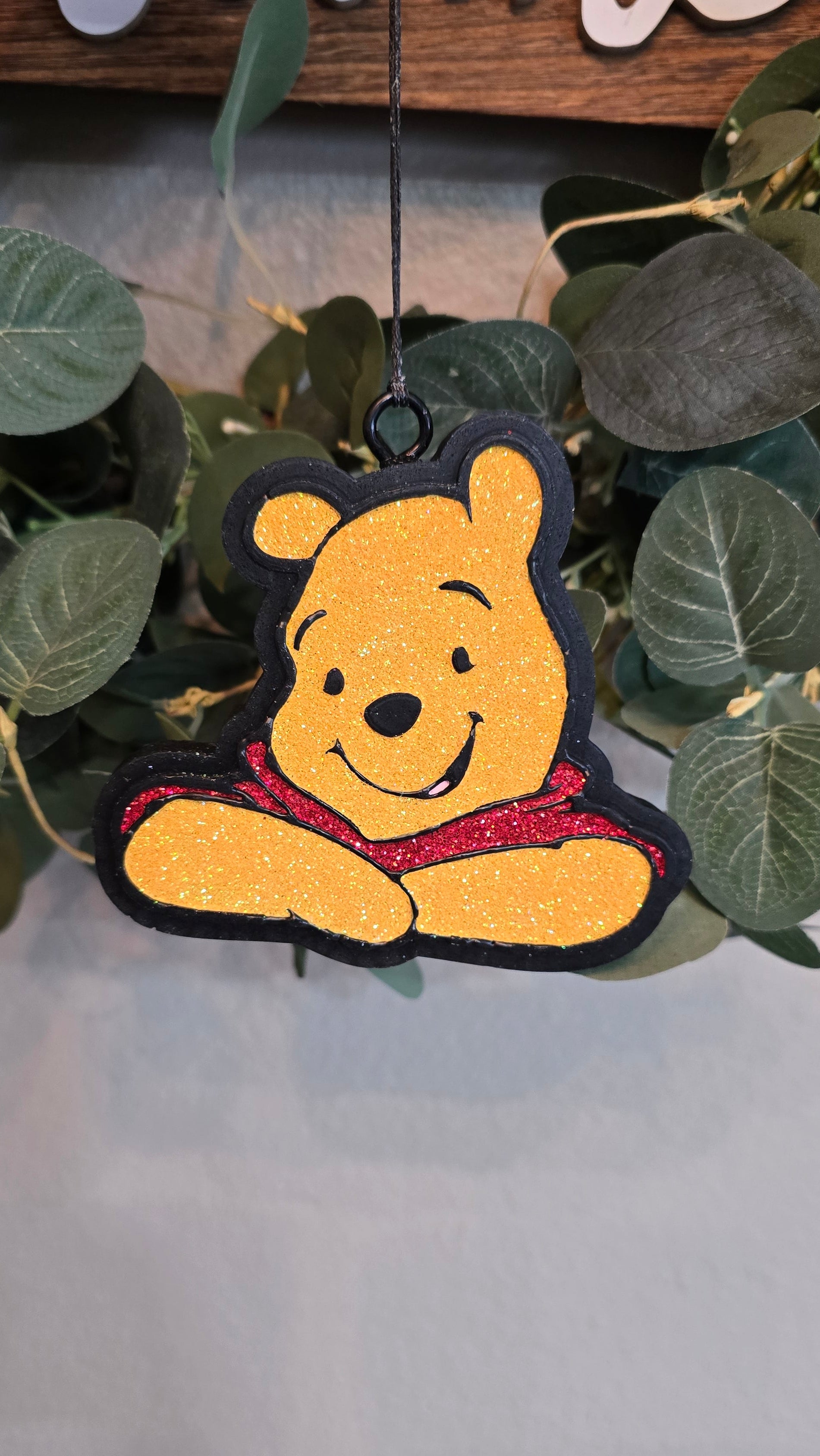 Handmade honey bear-inspired car freshie featuring a smiling bear wearing a red shirt, designed as a scented rearview mirror accessory.